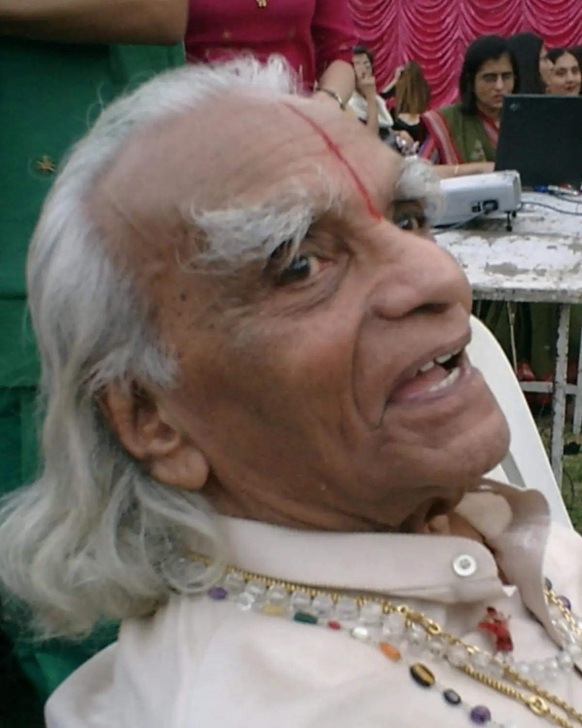 B.K.S. Iyengar in his later years, smiling, at a public gathering